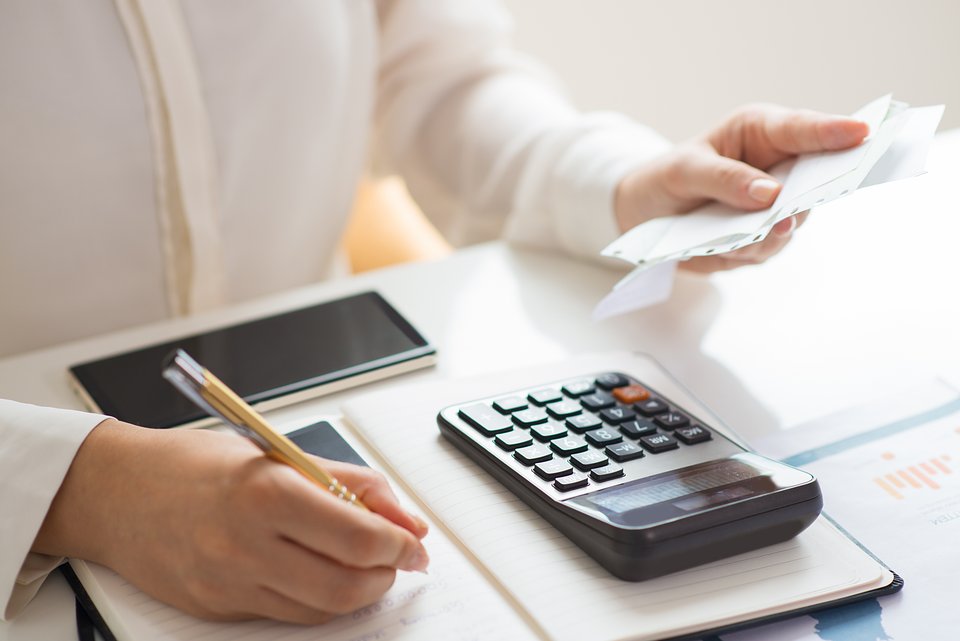 closeup-person-holding-bills-calculating-them.jpg