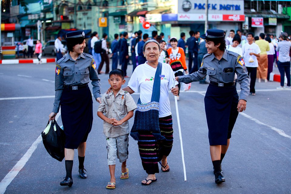 Two policewomen help a blind lady crossing the street in busy Yangon (Ye Kyaw Thu/AGORA images)