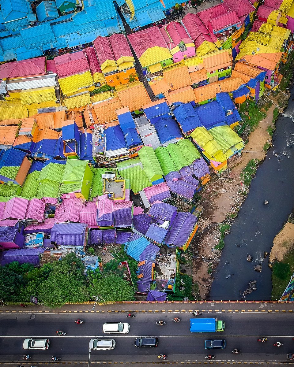 Taken in Malang, Indonesia. A few years back, the government tried to relocate people living in this slum, but some locals repainted all the houses with flashy colours to get the attention from tourists. The money they make now from tourism helped improving their living conditions. (Thijs Peters/AGORA images)