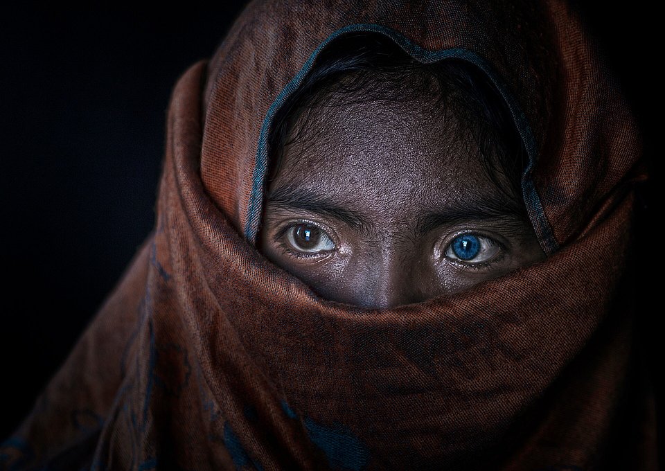 Upon a visit to Phan Rang city, the photographer got impressed with this little girl's eyes. Her name is Sapa from the Champa ethnic minority group (she's wearing the traditional scarf). Her brothers and sisters have whether brown or blue eyes, she has both. (Do Tuang/AGORA images)